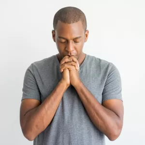calm-spiritual-handsome-african-guy-praying-with-closed-eyes